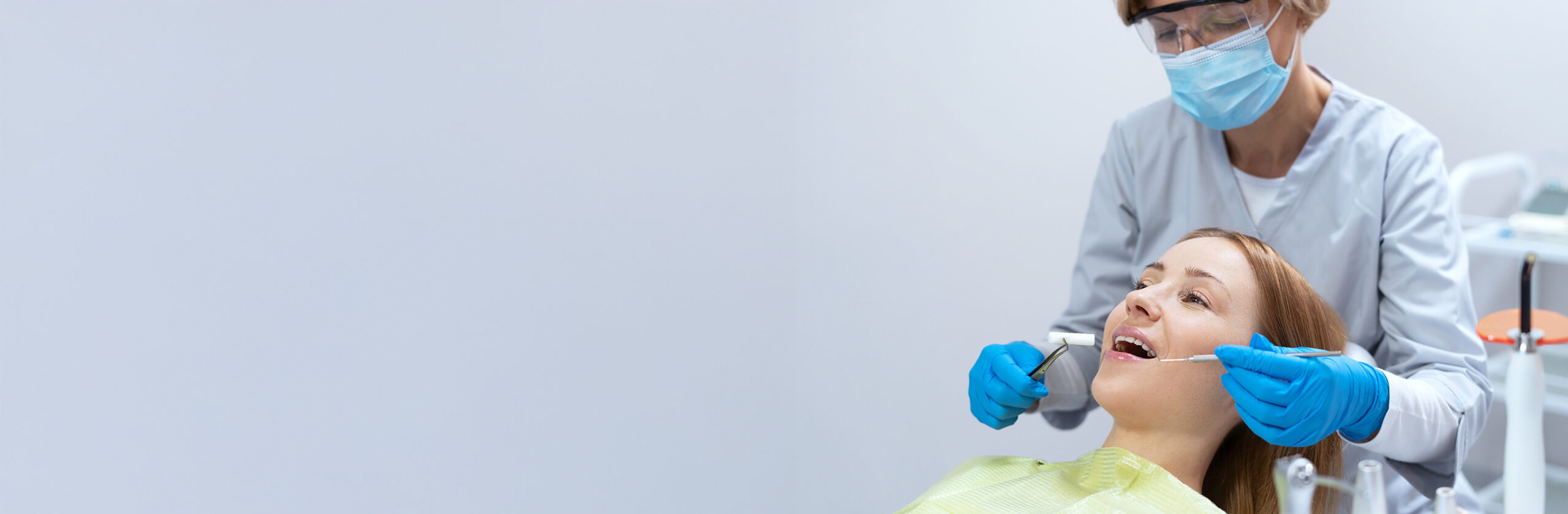 Side,View,Of,Doctor,Treating,Patients,Teeth,Using,Dental,Instruments.