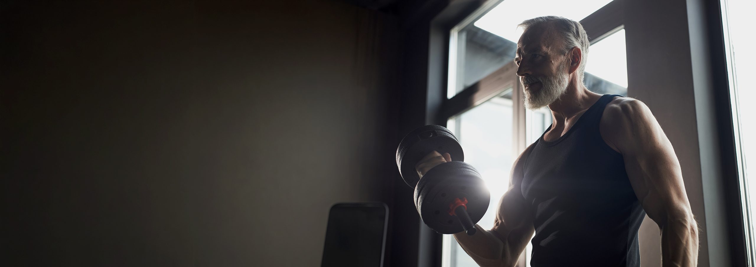 Senior,Caucasian,Man,Lifting,Dumbbell,In,Gym,,Showing,Muscular,Arms