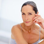 Portrait, skincare and woman with pride in studio with cosmetics, botox facial and dermatology treatment. Proud, mature female and beauty for wellness, natural glow and anti aging on white background