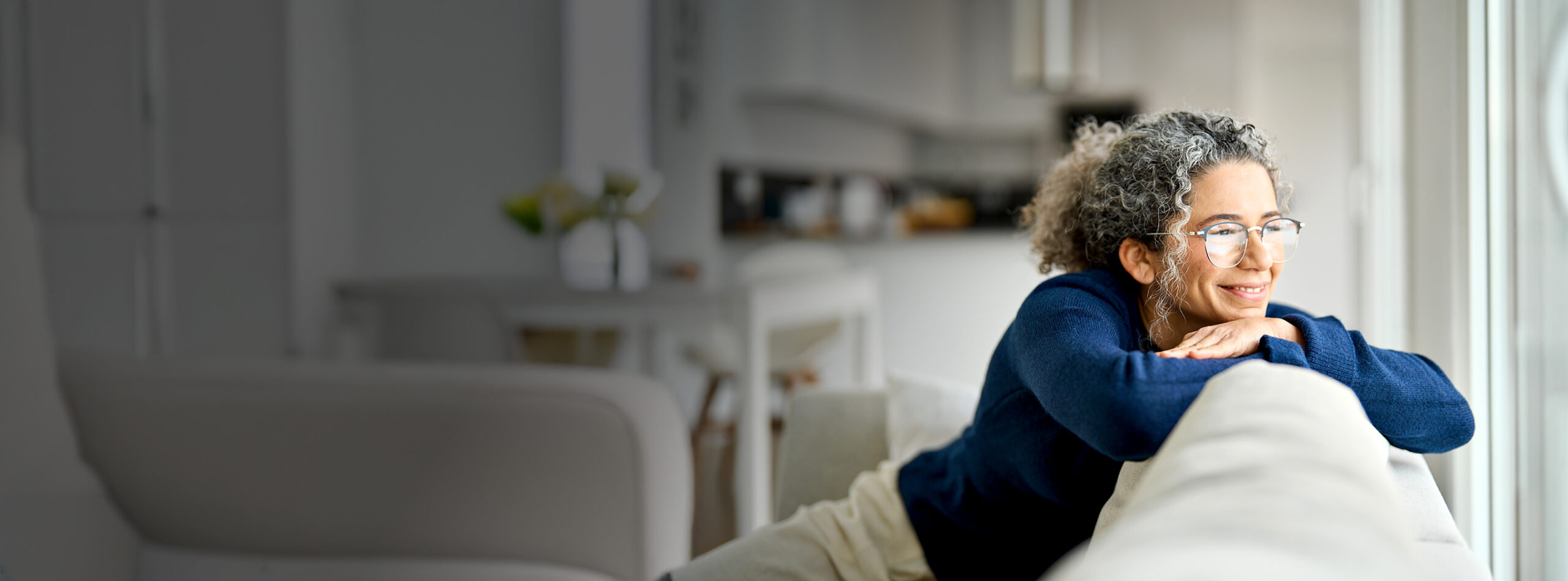 Happy,Middle,Aged,Woman,Sitting,On,Comfy,Sofa,In,Living