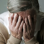 1140-alzheimer-myths-woman-hiding-face-esp