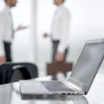 Modern workplace in office. Laptop on desk close up.